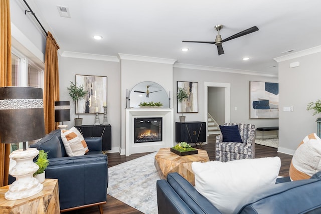 living room featuring ceiling fan, crown molding, and dark hardwood / wood-style floors