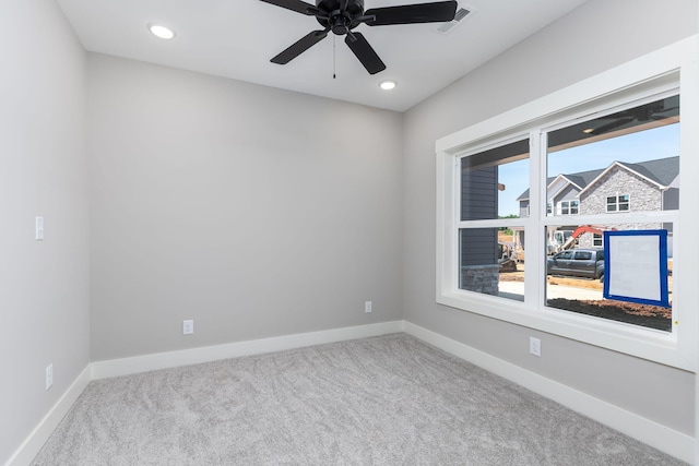 carpeted spare room with ceiling fan and a healthy amount of sunlight