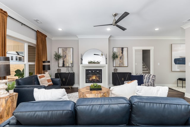 living room featuring ceiling fan, wood-type flooring, and ornamental molding