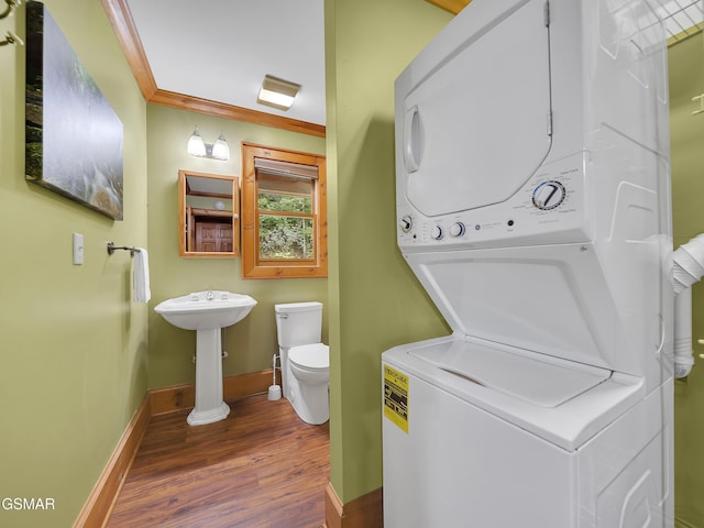 3541 Twin Pines Way, Sevierville, TN 37876 - laundry room with stacked washer / dryer, baseboards, wood finished floors, and crown molding