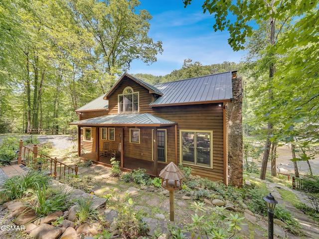 3541 Twin Pines Way, Sevierville, TN 37876 - rear view of house featuring covered porch, metal roof, and a chimney