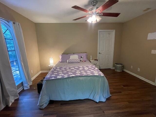 bedroom with ceiling fan and dark hardwood / wood-style floors