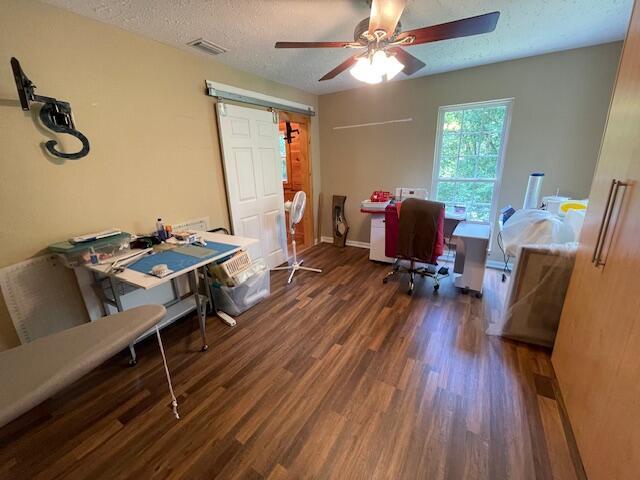 office featuring dark hardwood / wood-style flooring, a textured ceiling, and ceiling fan