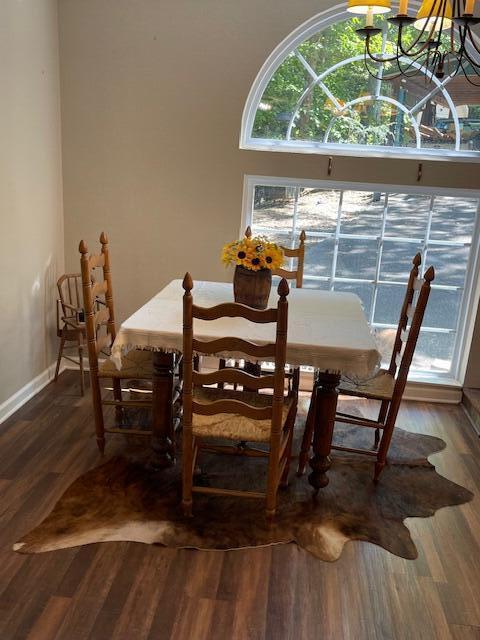 dining room with a chandelier and hardwood / wood-style flooring