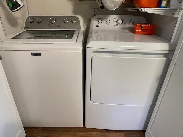 laundry room with washing machine and dryer and dark hardwood / wood-style floors