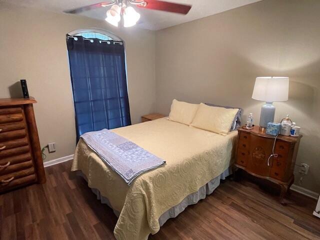 bedroom with ceiling fan and dark hardwood / wood-style flooring