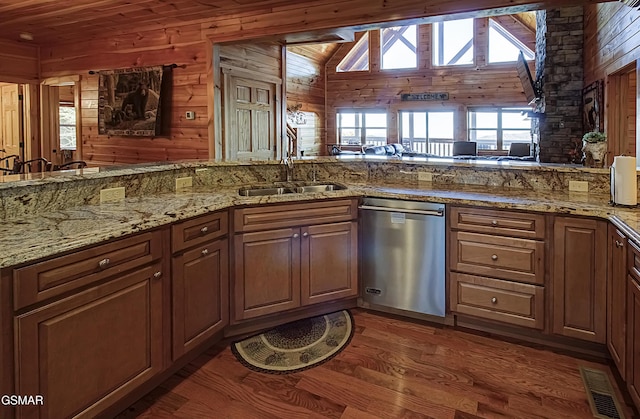 2422 Majestic View Way, Sevierville, TN 37862 - kitchen featuring stainless steel dishwasher, a sink, wood walls, wood finished floors, and light stone countertops