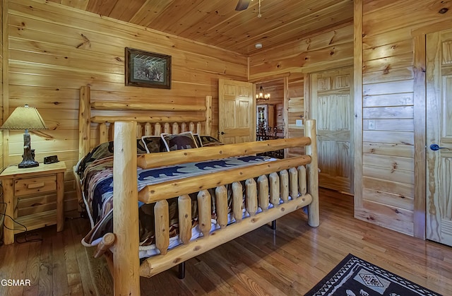 2422 Majestic View Way, Sevierville, TN 37862 - bedroom featuring hardwood / wood-style flooring, wooden walls, wood ceiling, and a chandelier