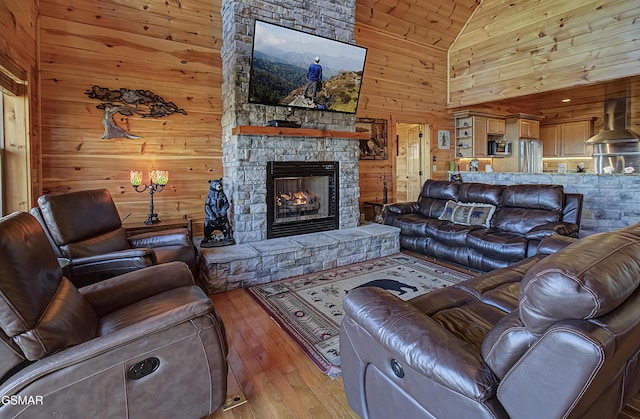 2422 Majestic View Way, Sevierville, TN 37862 - living room with wooden walls, high vaulted ceiling, a stone fireplace, and hardwood / wood-style floors