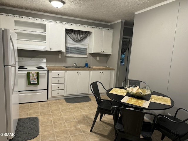 kitchen with a sink, white appliances, under cabinet range hood, and white cabinets
