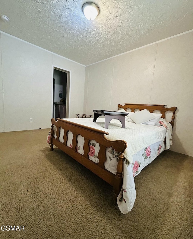 bedroom featuring carpet floors and a textured ceiling