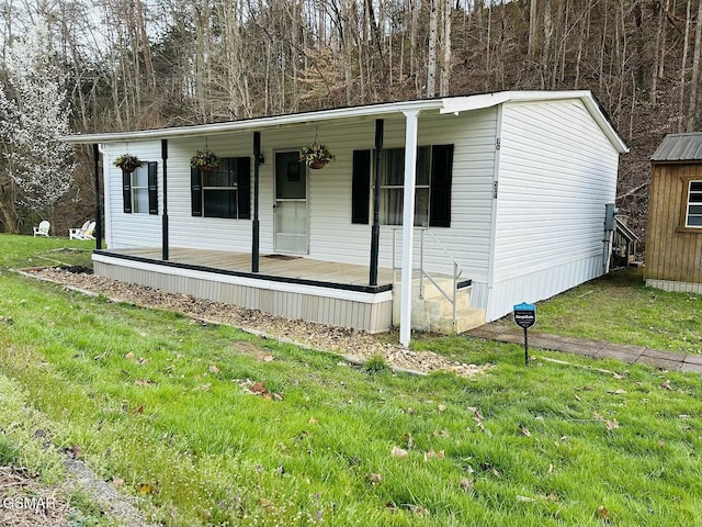 manufactured / mobile home with a porch and a front lawn