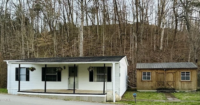 view of front facade with a porch, a shed, and an outdoor structure
