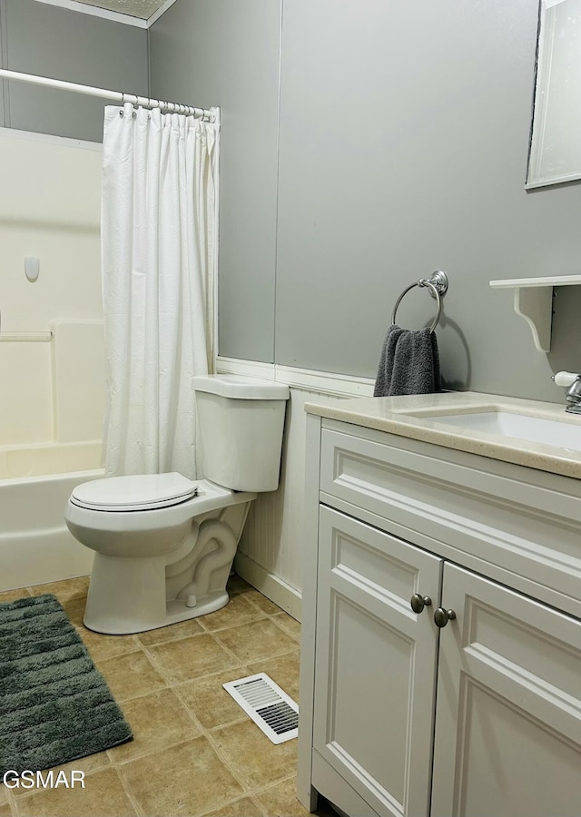 bathroom featuring vanity, shower / bath combo with shower curtain, toilet, and visible vents