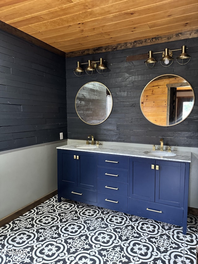 bathroom featuring double vanity, tile patterned flooring, wood ceiling, and a sink