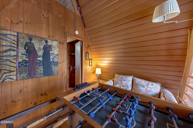 unfurnished bedroom featuring lofted ceiling and wooden walls