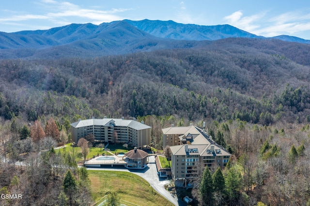 drone / aerial view with a forest view and a mountain view