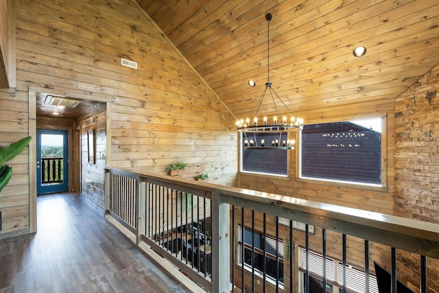 hallway featuring wood ceiling, high vaulted ceiling, a notable chandelier, dark hardwood / wood-style floors, and wood walls