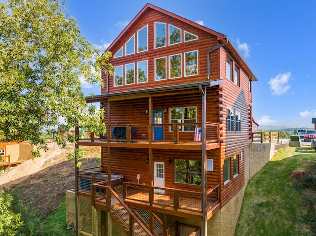 rear view of property with a wooden deck