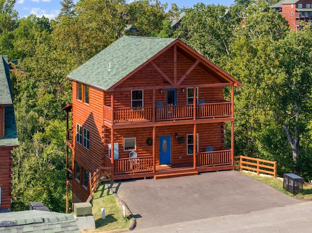 log-style house featuring a balcony