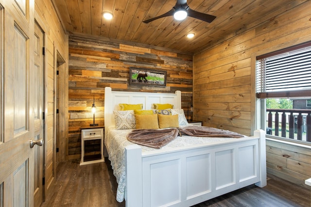 bedroom featuring ceiling fan, wooden ceiling, dark wood-type flooring, and wooden walls