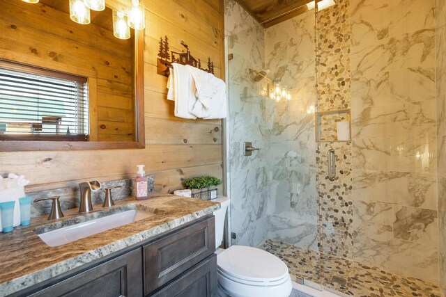 bathroom featuring wooden walls, toilet, vanity, and walk in shower