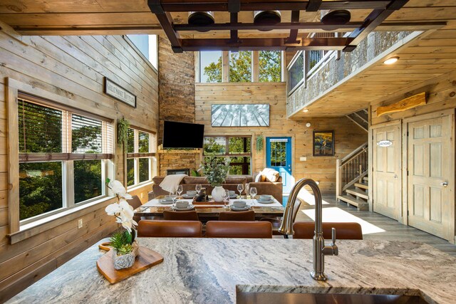 interior space with a fireplace, beam ceiling, and sink