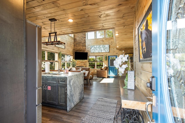 kitchen with light stone countertops, sink, hanging light fixtures, high vaulted ceiling, and wood ceiling