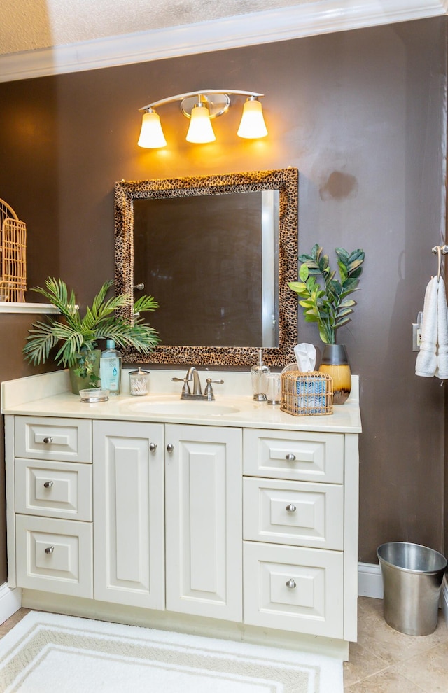 bathroom with tile patterned flooring, vanity, and crown molding