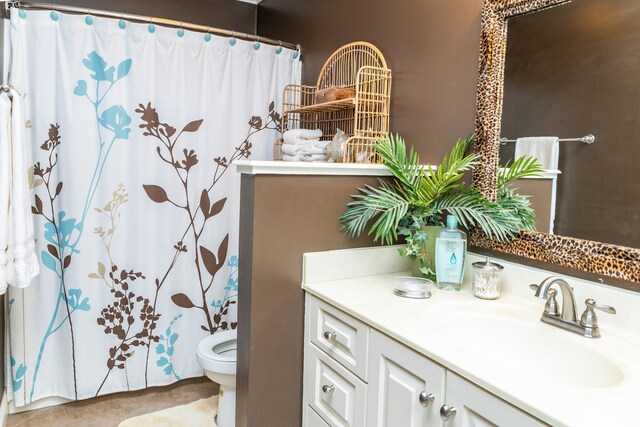 bathroom featuring tile patterned floors, vanity, and toilet