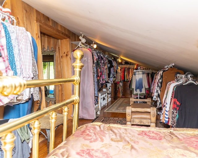 walk in closet featuring wood-type flooring and vaulted ceiling