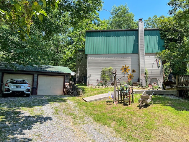 exterior space featuring a garage and an outbuilding