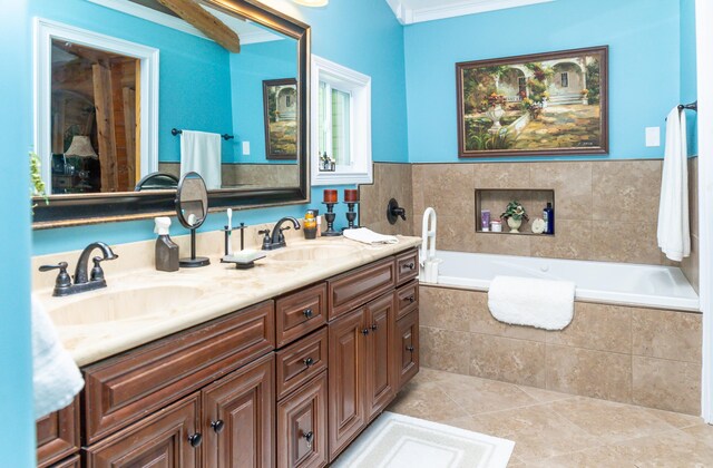 bathroom with tile patterned flooring, vanity, a relaxing tiled tub, and ornamental molding