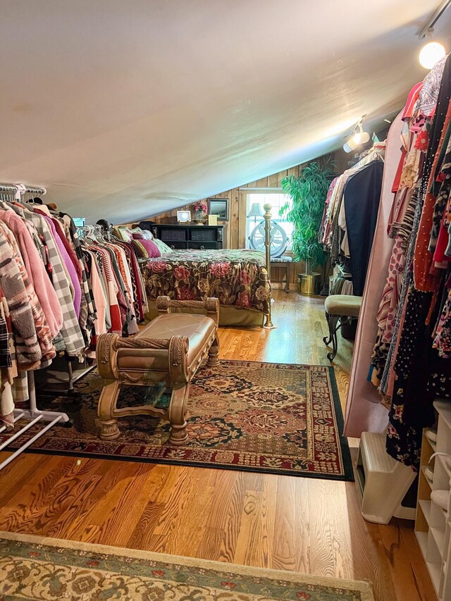 walk in closet featuring hardwood / wood-style floors and vaulted ceiling