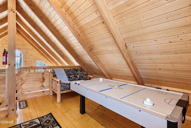 playroom featuring light wood-type flooring, vaulted ceiling with beams, wooden ceiling, and wood walls