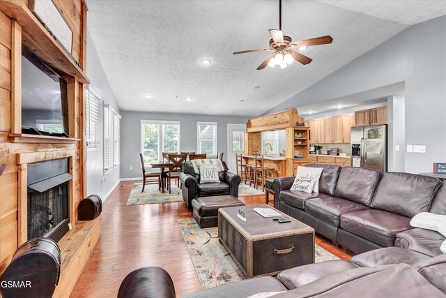 2259 Hartford Rd, Cosby, TN 37722 - living area featuring a fireplace, a ceiling fan, recessed lighting, vaulted ceiling, and light wood finished floors