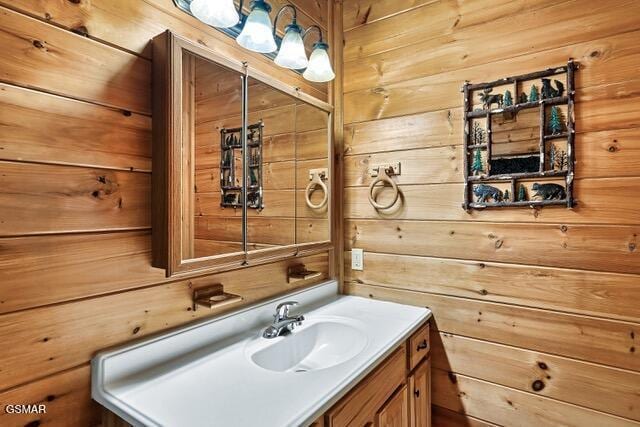 bathroom with wood walls and vanity