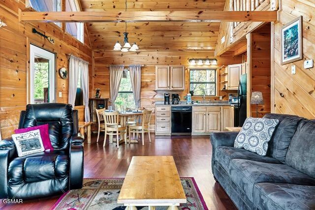 living room featuring a chandelier, dark hardwood / wood-style flooring, high vaulted ceiling, and a wealth of natural light