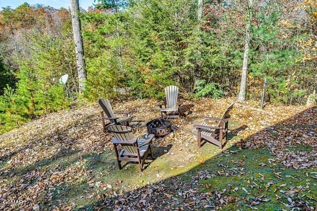 view of yard with an outdoor fire pit