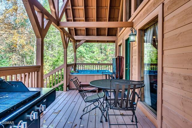 wooden terrace with a hot tub