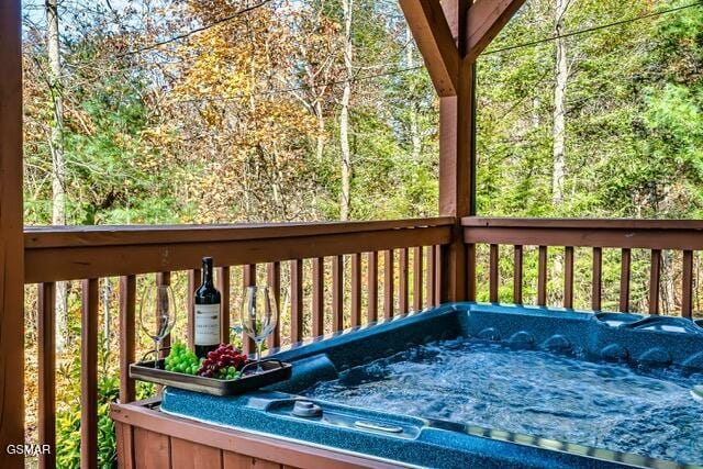 wooden deck with a hot tub