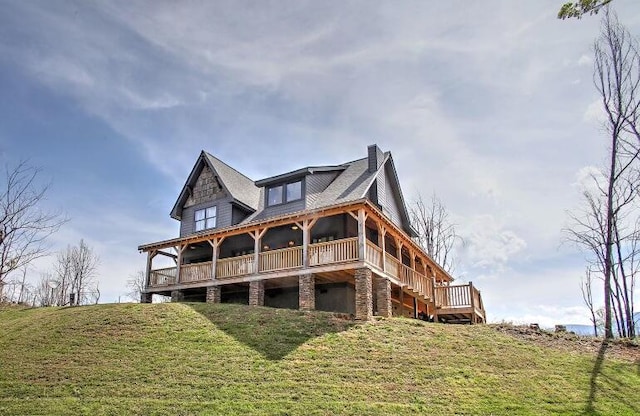 rear view of property featuring a lawn