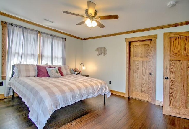 bedroom with dark hardwood / wood-style floors and ceiling fan