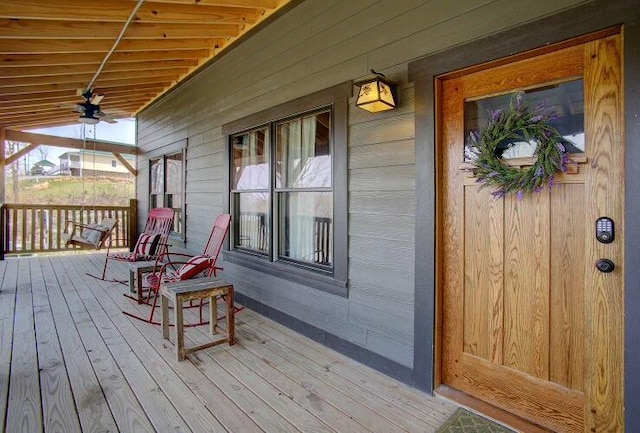 wooden terrace featuring ceiling fan and covered porch