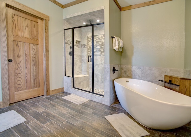 bathroom featuring ornamental molding and plus walk in shower