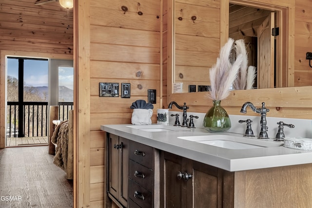 bathroom featuring vanity and wooden walls