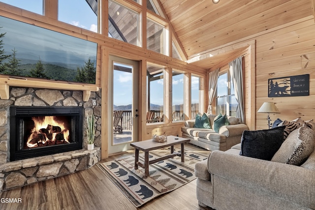 sunroom / solarium featuring a wealth of natural light, a fireplace, and vaulted ceiling