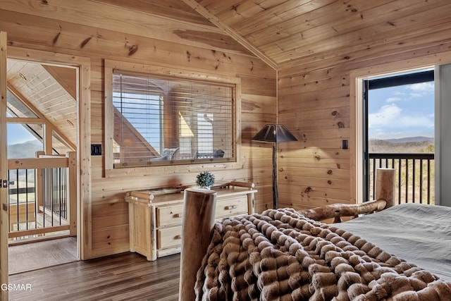 bedroom with dark wood-type flooring, lofted ceiling, wood walls, wooden ceiling, and a mountain view