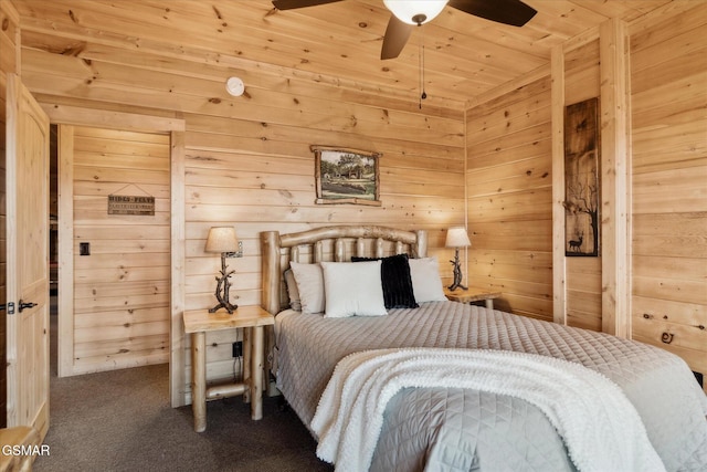 bedroom with ceiling fan, wood walls, carpet, and wooden ceiling