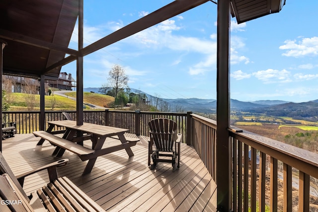 wooden deck with a mountain view